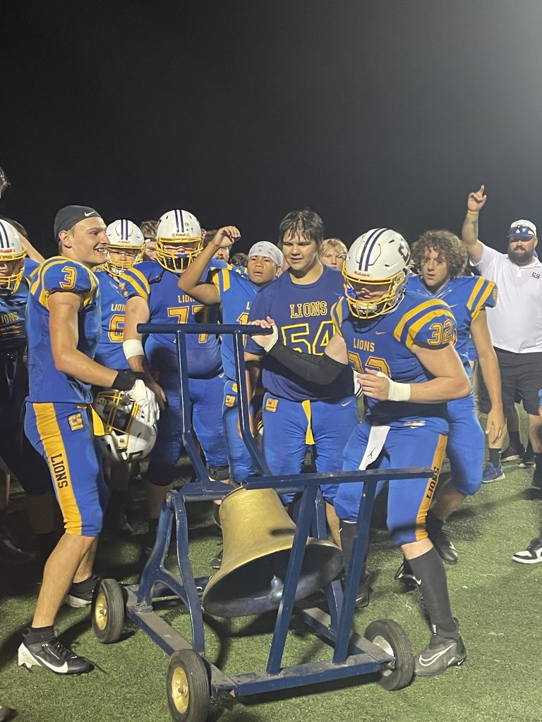 MCKENZIE DAYS / CHRONICLE PHOTO The Lions celebrating their home opener win by ringing their bell--marking their second win in just two weeks.